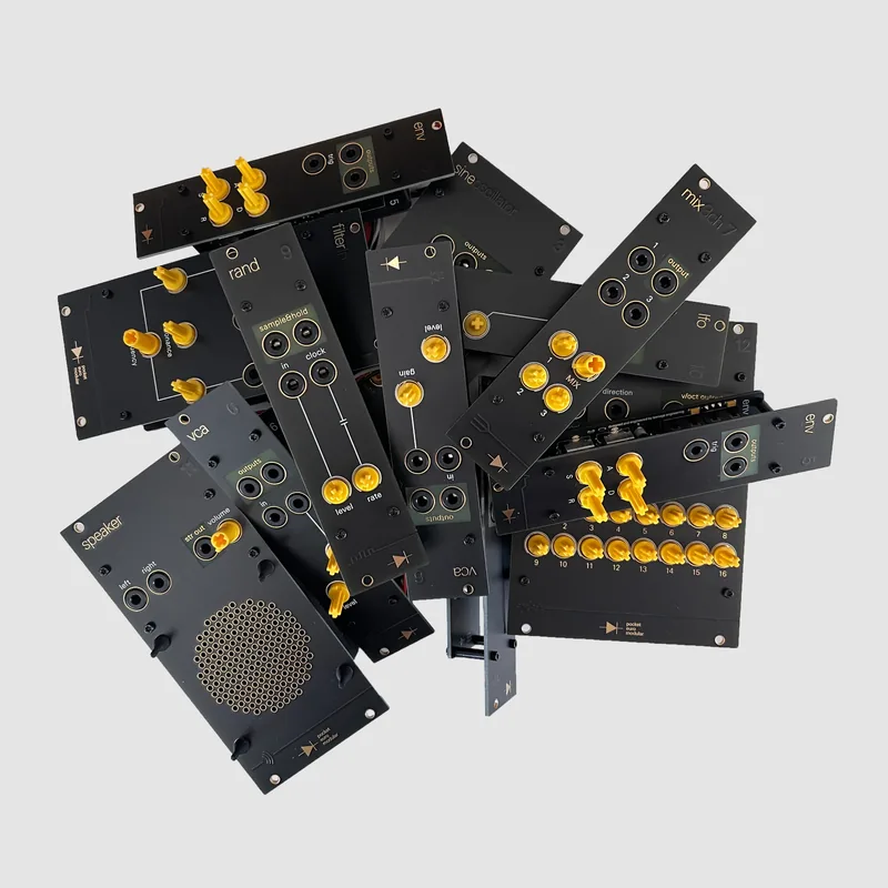 A pile of black Pocket Operator Modular panels with yellow jacks